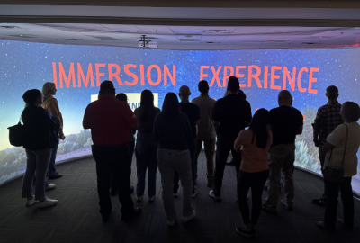 Group of people in front of large screen for immersion lab