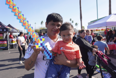 Father holding his son and a toy