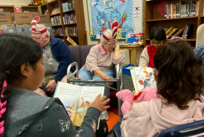 Golden Neighbors reading to students