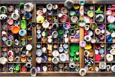 Overheard view of a drawer full of multi-colored clay thumbprints