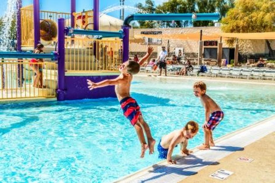 boy jumping into pool