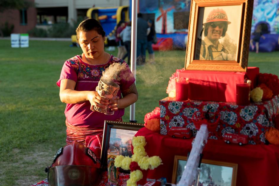 Woman decorating the CFD altar at the 2018 Day of the Dead Festival