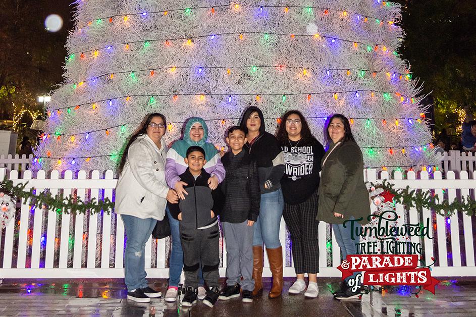 Family poses in front of Chandler Tumbleweed Tree