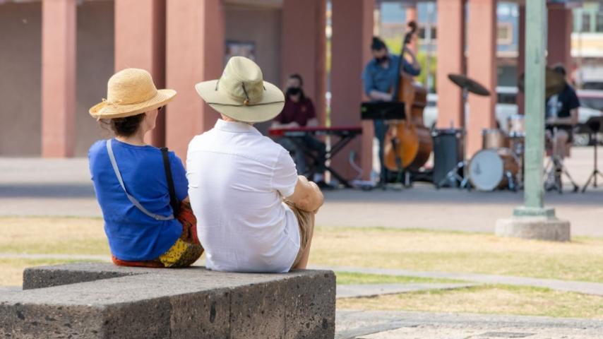 Couple enjoying an outdoor performance in Downtown Chandler