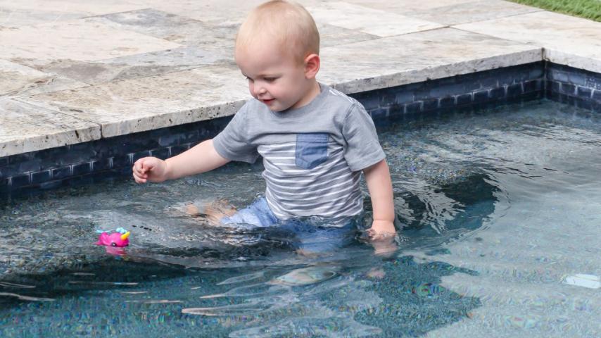 toddler playing in pool