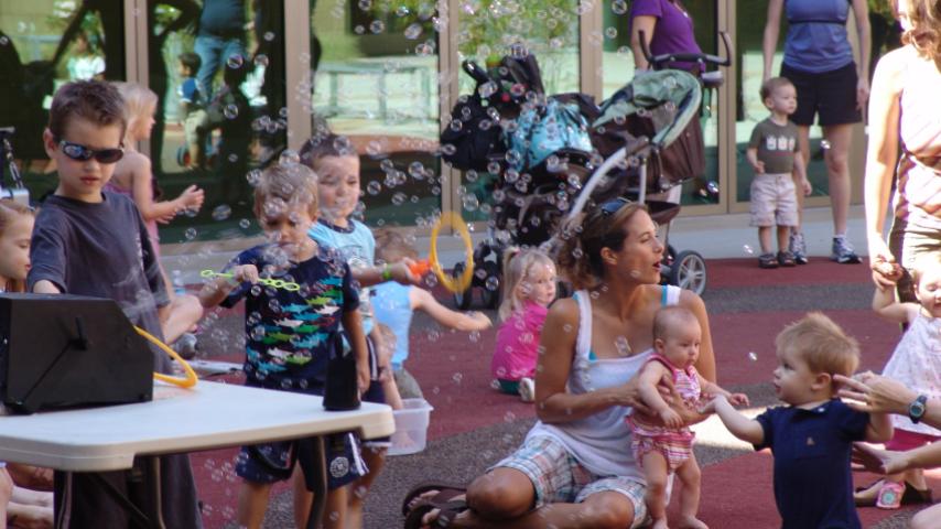 kids blowing bubbles outside