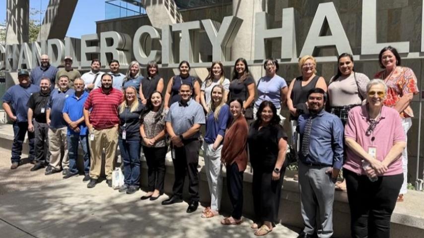 Group of new employees standing outside of city hall