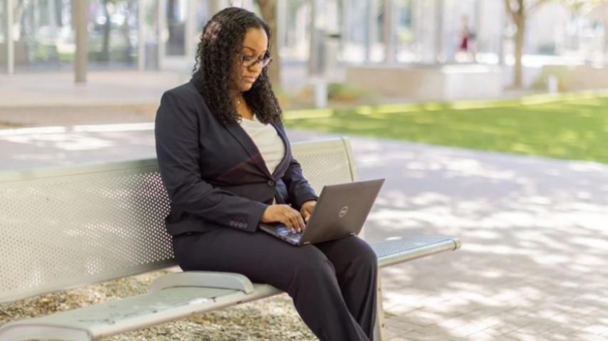 Professional woman working on a lap top outside city hall