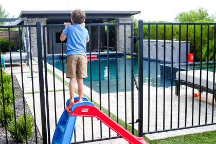 Water Safety Boy Looking Over Pool Fence