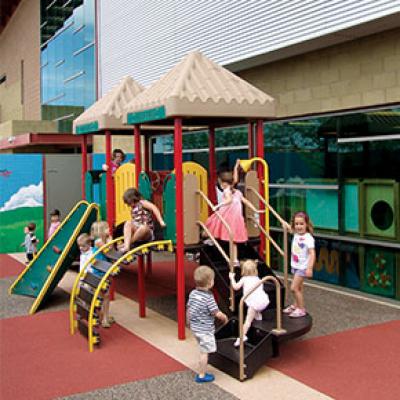 Children playing on an indoor play set at Tumbleweed Recreation Center