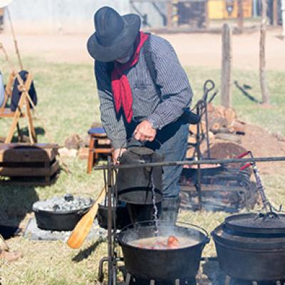 Tending to a campfire meal at the 2017 Chuck Wagon Cookoff