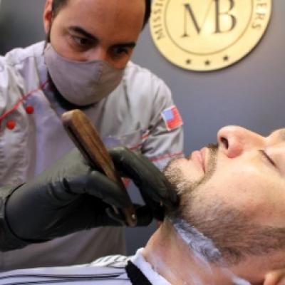Barber wearing masks while cutting hair