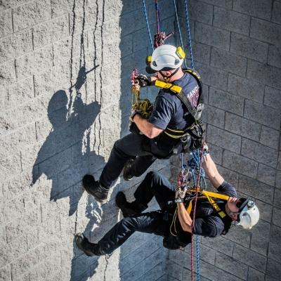 Firefighters scaling side of the building