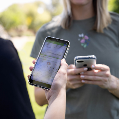 Water Conservation staff using the instant language assistant device in the field