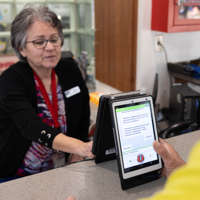 City staff using the instant language assistant device at the Senior Center