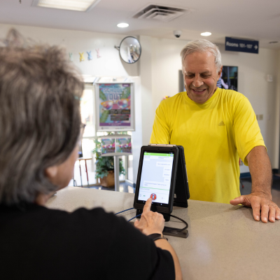 Resident using the instant language assistant device at the Senior Center