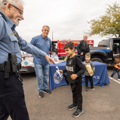 Child interacting with Police volunteer at Airport Day