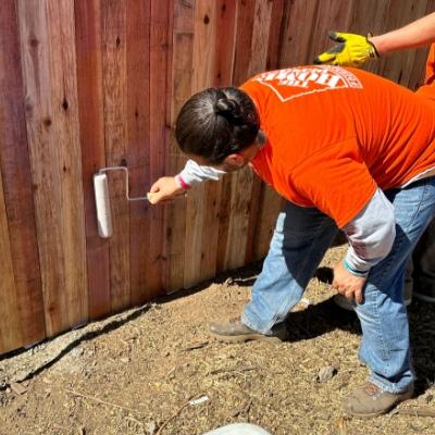 man painting a fence