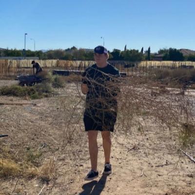 young man clearing tumbleweeds