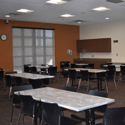 Tables, chairs, glass door and prep-area at the Nature Center