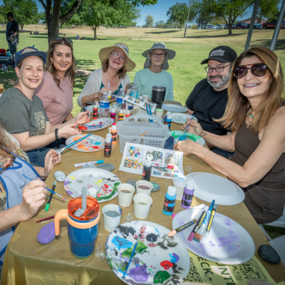 For Our City Day volunteers painting rocks with inspiring messages