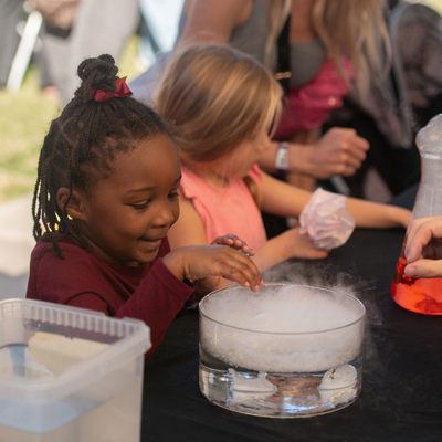 young child experimenting with dry ice at the 2026 CIF