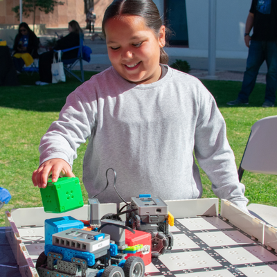 young girl experimenting with a robot