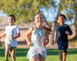 Kids running through a neighborhood common area Kids running through a neighborhood common area