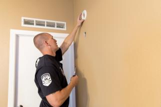 Chandler Fire testing a resident's smoke alarm