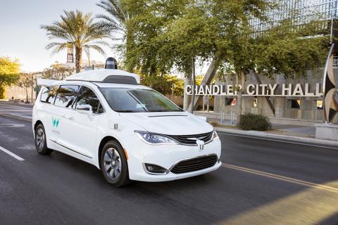 Waymo vehicle driving in front of Chandler City Hall.