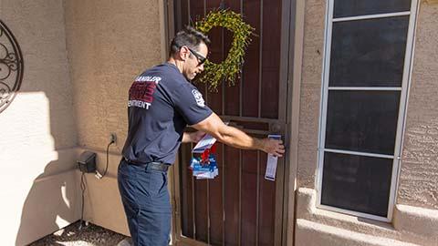 fireman at a doorstep during the Chandler Water Safety Walk