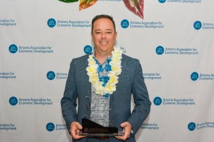 Micah Miranda with his EDDE award for  Economic Developer of the Year 