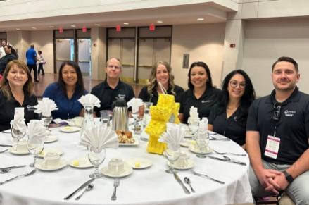 Neighborhood Resources Team seated at luncheon: Leah Powell, LaTisha Gilmore, Guy Jaques, Tawna Mower, Priscilla Quintana, Erica Barba and Phillip Hubbard