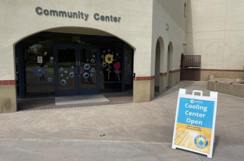 Exterior of Chandler Community Center with A-frame sign with text: Cooling Center Open)