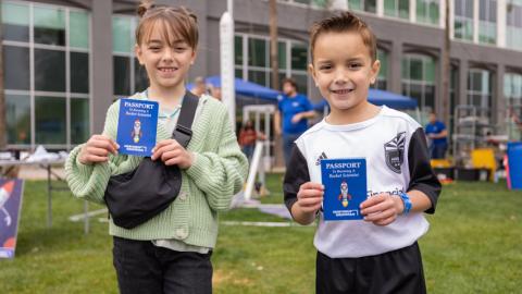 Kids holding passports at Chandler Innovation Fair