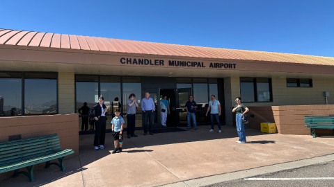 Residents waiting for the tour bus to take them around the airfield during an airport tour