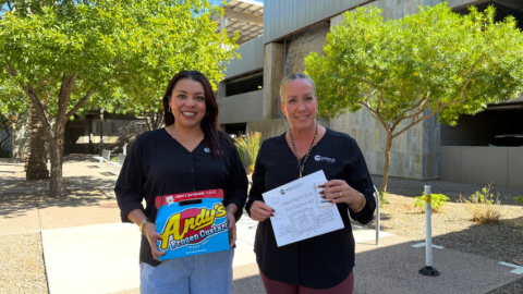 Neighborhood Programs team: Priscilla Quintana and Tawna Mower holding Andy's Custard and neighborhood handout