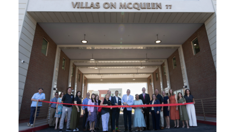 City of Chandler executives and partners in front of a red ribbon at Villas on McQueen