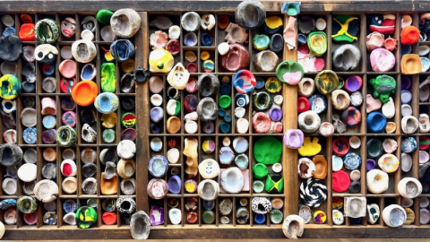 Overheard view of a drawer full of multi-colored clay thumbprints