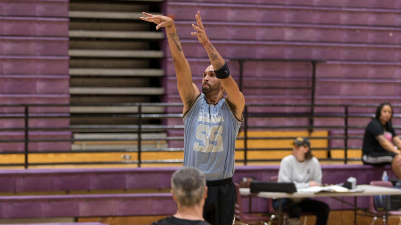 adult man shooting the basketball