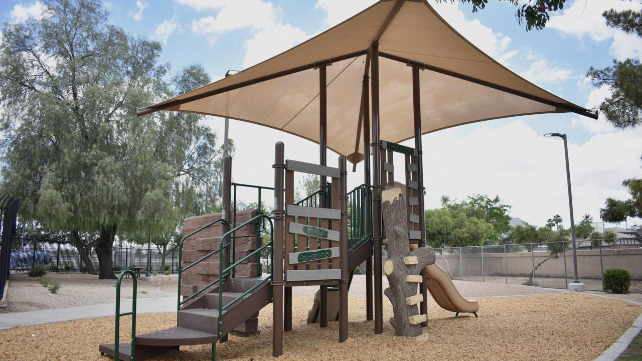 Playground climbing structure and slide at Desert Oasis Park