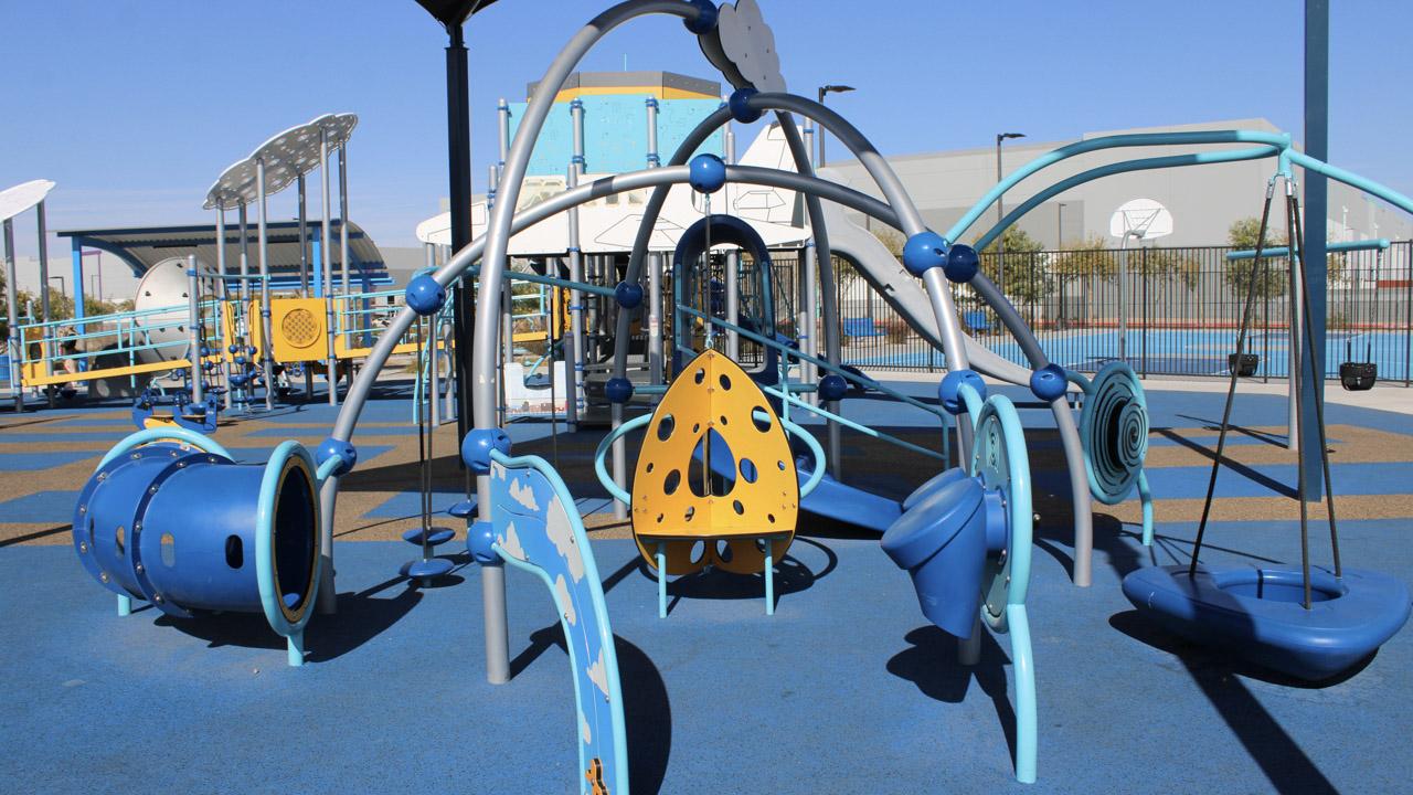 Small playground with tunnels and climbing features at Lantana Ranch Park