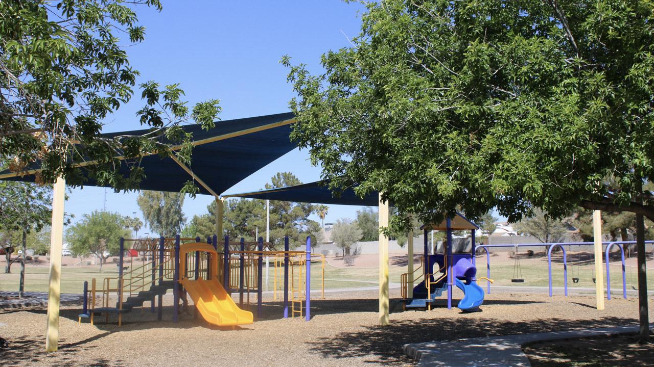 Play area with slides and swings at Stonegate Park