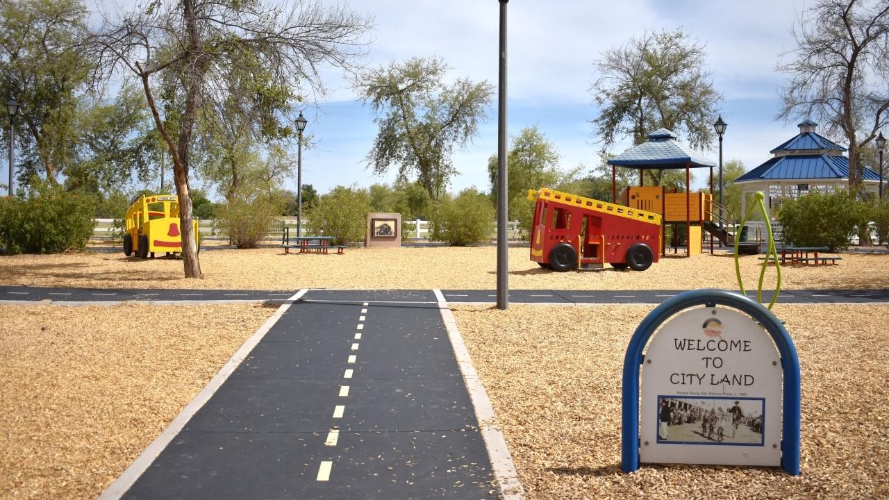 City Land Playground With Interactive Buses And Play Structure At Tumbleweed Park