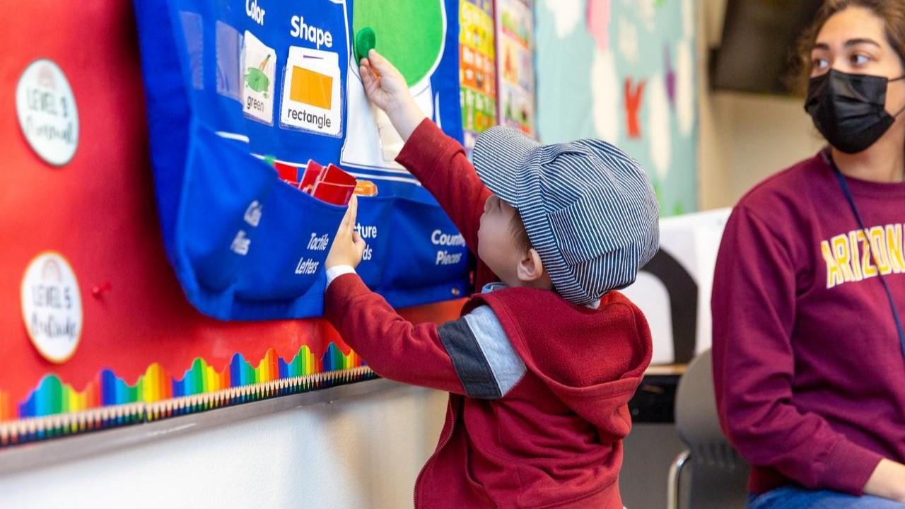 Young boy in interacting in building blocks classroom