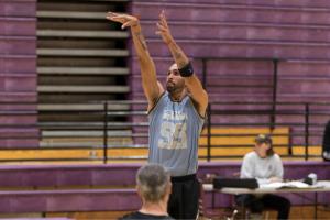 adult man shooting the basketball