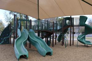 Playground climbing wall and slides at Blue Heron Park