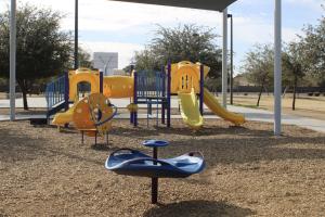 Small playground with three slides at Centennial Park