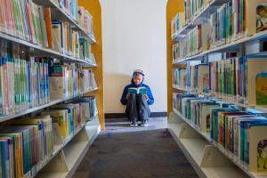 teen reading at library