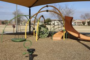Play area with slide and spring rider at Citrus Vista Park